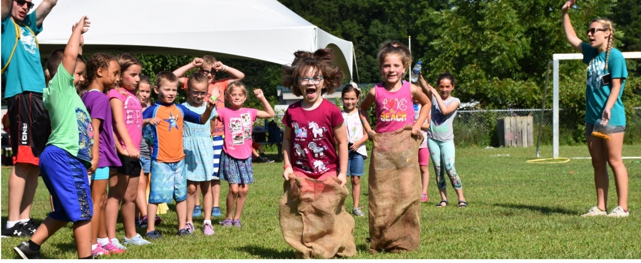 Kids sack racing Kids playing at Sussex County YMCA summer day camp